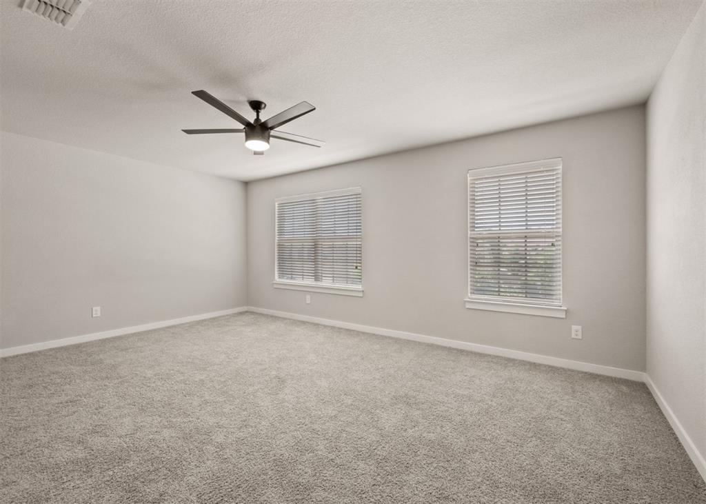 2521 Boot Jack Road Fort Worth, TX 76177 - Photo 30 of 40 an empty room with windows and ceiling fan
