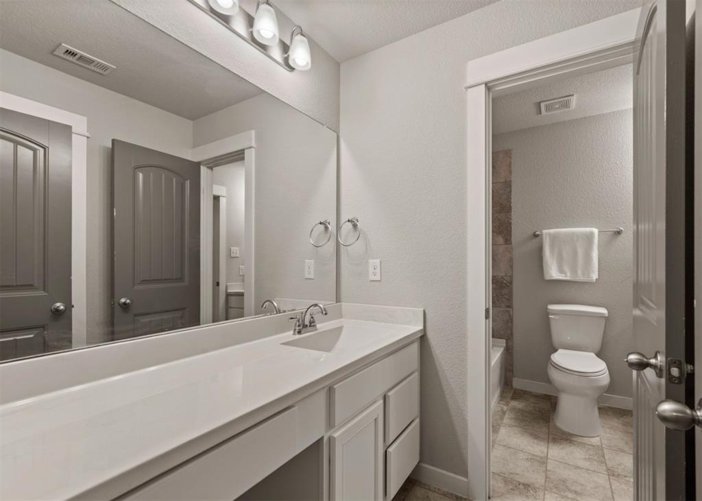 2521 Boot Jack Road Fort Worth, TX 76177 - Photo 35 of 40 a bathroom with a sink a toilet and a mirror