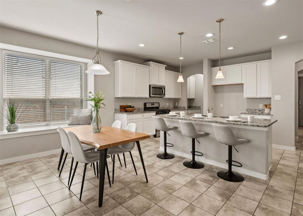 2521 Boot Jack Road Fort Worth, TX 76177 - Photo 10 of 40 a kitchen with stainless steel appliances kitchen island granite countertop a table chairs and a sink