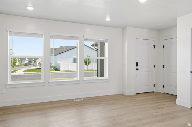 730 West 500 North Smithfield, UT 84335 - Photo 4 of 46 Open-concept room featuring light wood-finish flooring, recessed lighting, and multiple windows with blinds