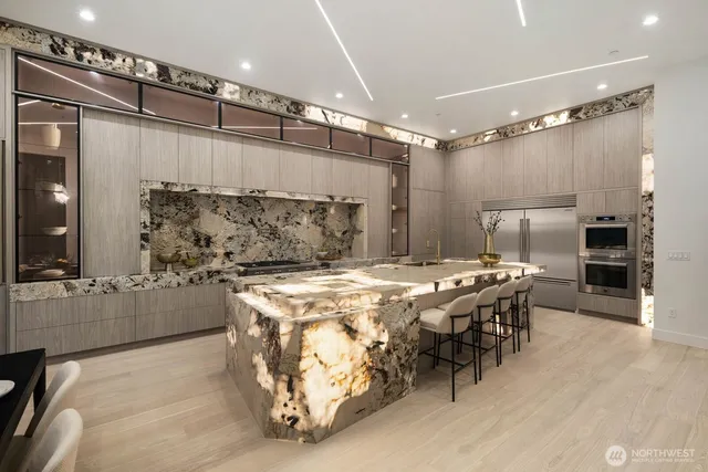 a kitchen with refrigerator and chairs