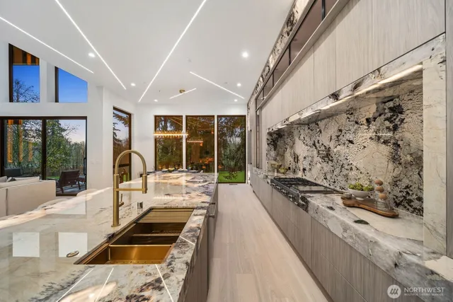 a large white kitchen with a large window
