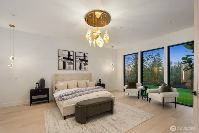 a bedroom with a bed and a chandelier