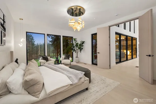 a bedroom with a bed mirror and window