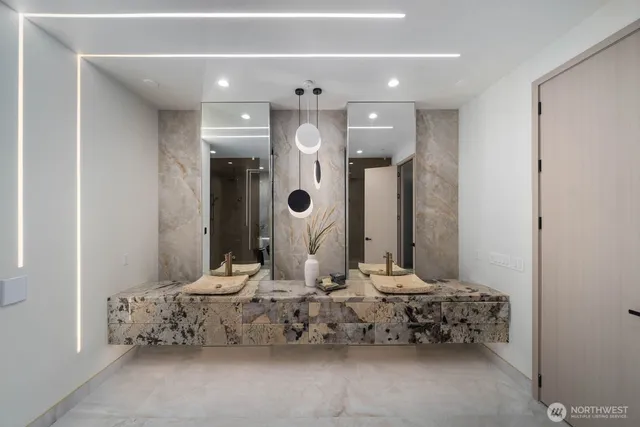 a bathroom with a double vanity sink and a mirror