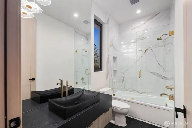 a spacious bedroom with a bed and glass window