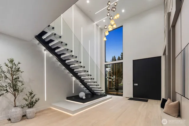 wooden floor in an empty room with a chandelier
