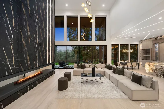 a living room with furniture and large windows