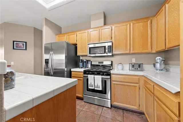 a kitchen with stainless steel appliances granite countertop a refrigerator stove a sink and dishwasher