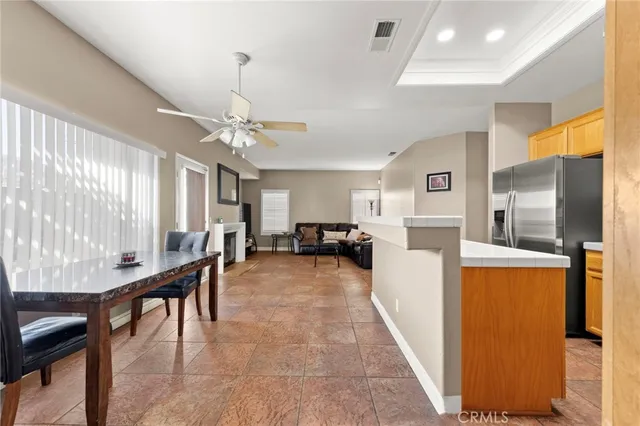 a living room with furniture a table and kitchen view