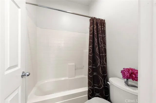 a bathroom with a bathtub a shower and a toilet