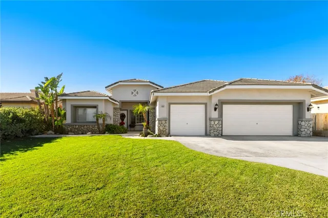 a view of a house with a yard and garage