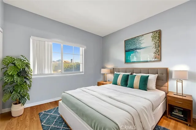 a bedroom with bed and a potted plant
