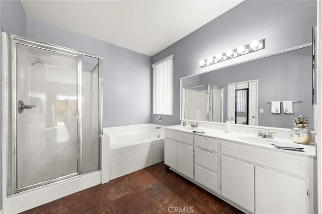 a spacious bathroom with a double vanity sink mirror and shower