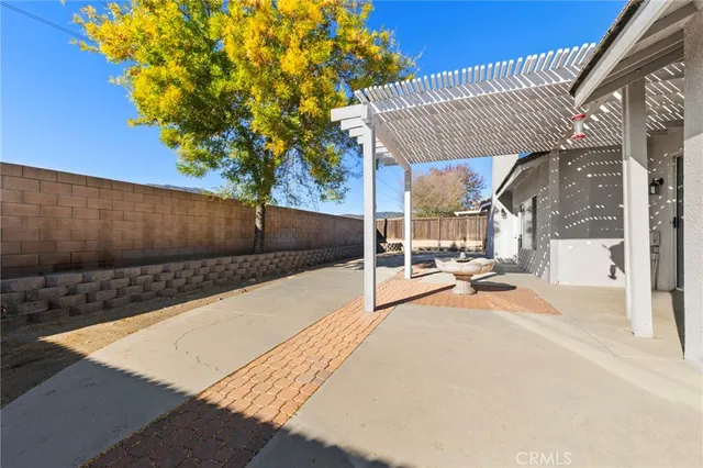 a view of a patio with table and chairs with wooden fence and plants