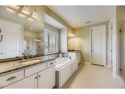 a bathroom with a tub and a shower