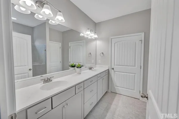 a hall with a sink and a mirror