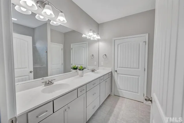 a hall with a sink and a mirror