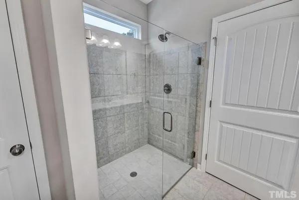 a bathroom with a glass shower door