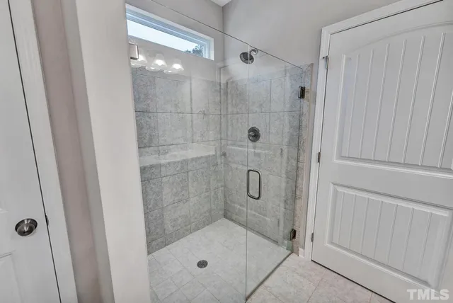 a bathroom with a glass shower door