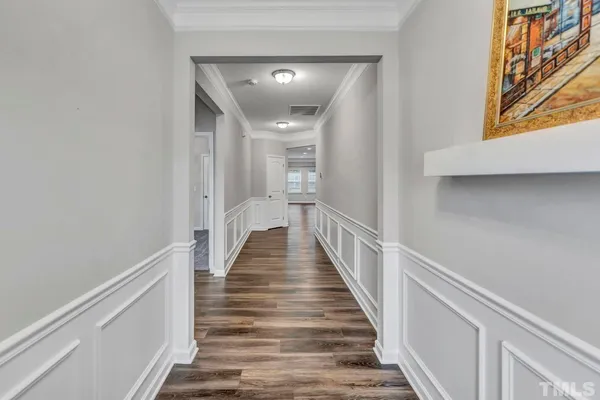 a view of a hallway with wooden floor and staircase