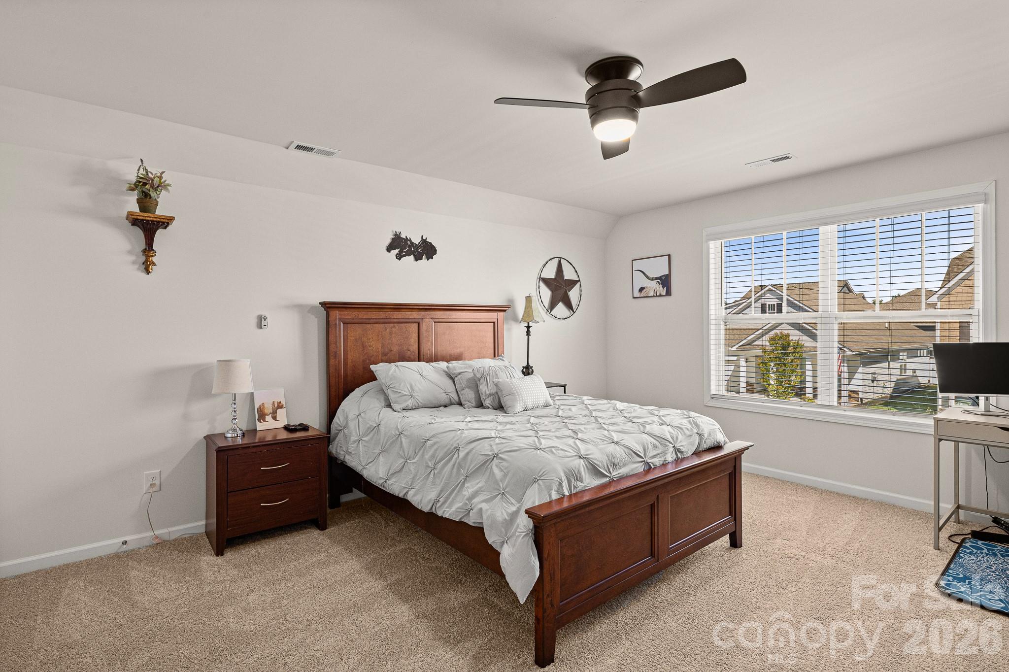 199 Fox Cove Road Hendersonville, NC 28792 - Photo 20 of 48 a bedroom with a bed and a chandelier