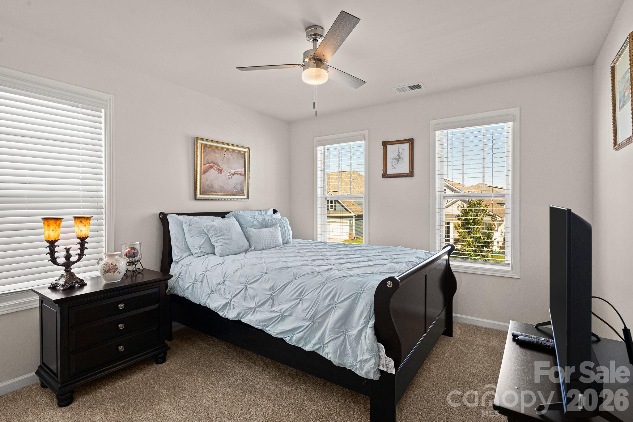 199 Fox Cove Road Hendersonville, NC 28792 - Photo 29 of 48 a bedroom with a bed and a flat tv screen on a dresser