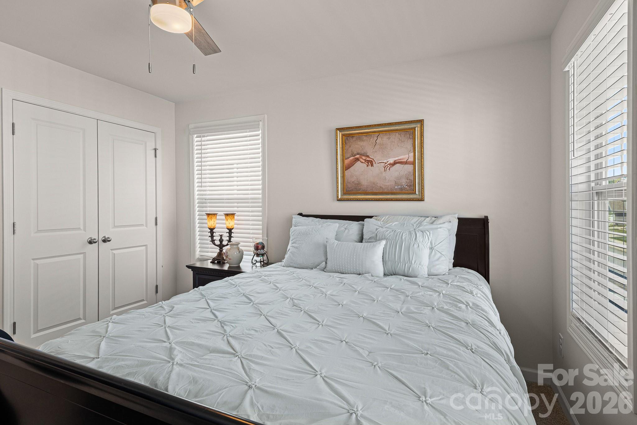 199 Fox Cove Road Hendersonville, NC 28792 - Photo 30 of 48 a bedroom with a large bed and a chandelier