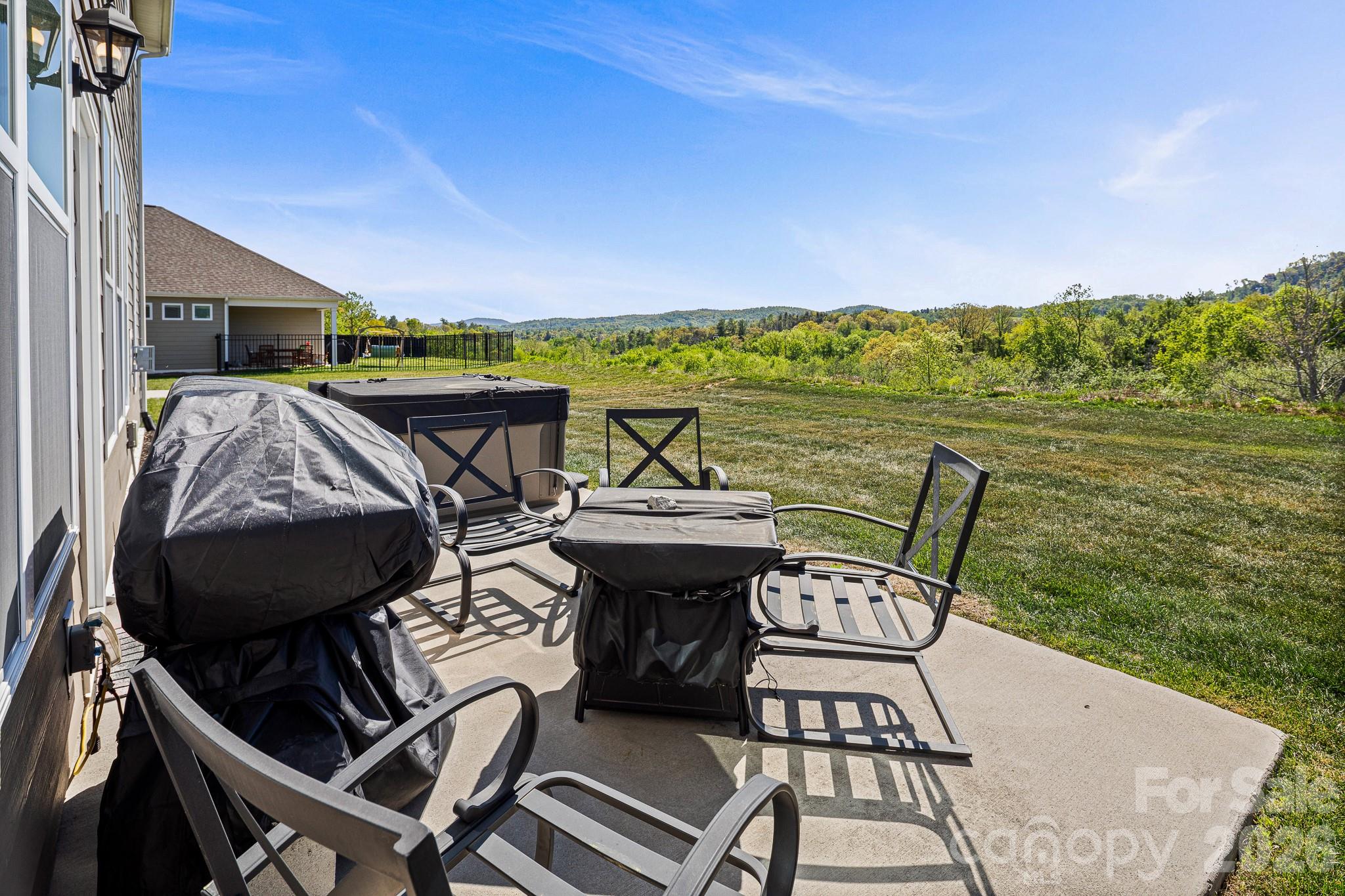 199 Fox Cove Road Hendersonville, NC 28792 - Photo 36 of 48 a view of a chairs and table on the terrace