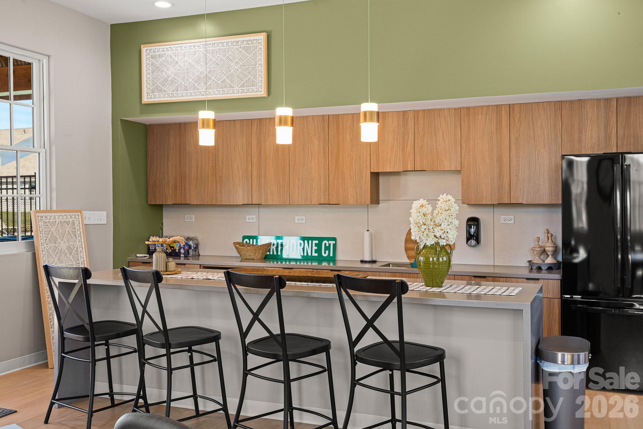 199 Fox Cove Road Hendersonville, NC 28792 - Photo 41 of 48 a kitchen with stainless steel appliances a dining table chairs and a refrigerator