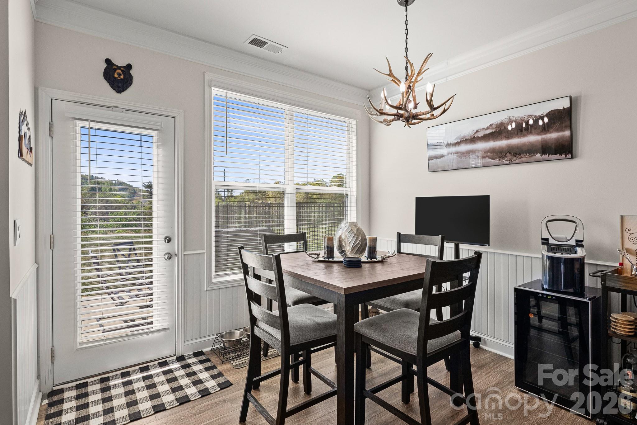 199 Fox Cove Road Hendersonville, NC 28792 - Photo 10 of 48 a view of a dining room with furniture window and wooden floor