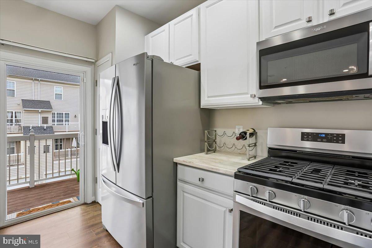 723 Main Street, Unit 723B Gaithersburg, MD 20878 - Photo 10 of 71 a kitchen with stainless steel appliances a refrigerator stove and microwave