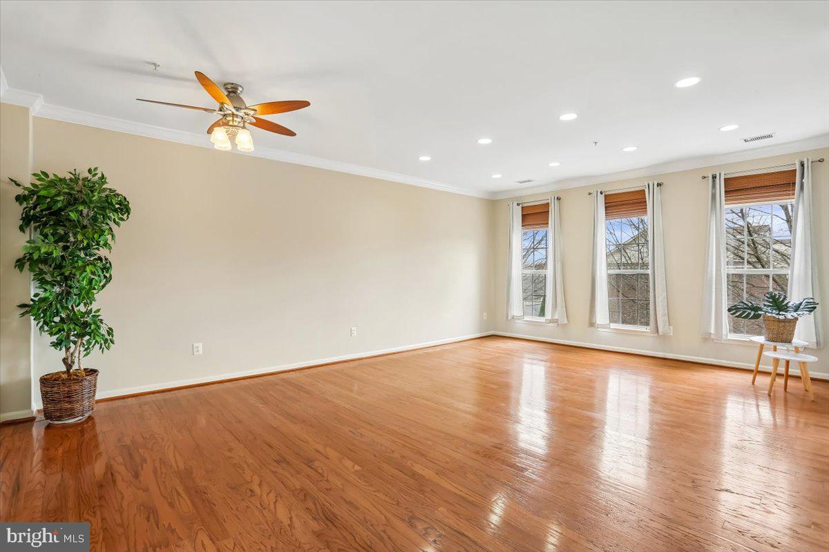 723 Main Street, Unit 723B Gaithersburg, MD 20878 - Photo 6 of 71 a view of empty room with wooden floor and fan