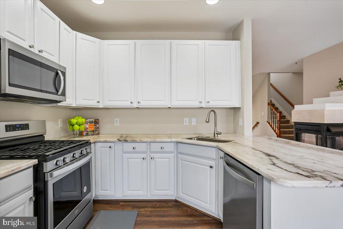 723 Main Street, Unit 723B Gaithersburg, MD 20878 - Photo 9 of 71 a kitchen with stainless steel appliances granite countertop a sink stove and cabinets