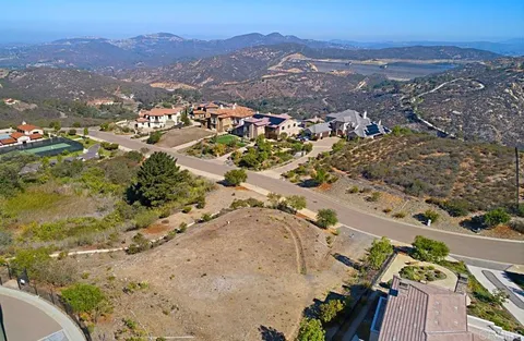 an aerial view of a house with a mountain