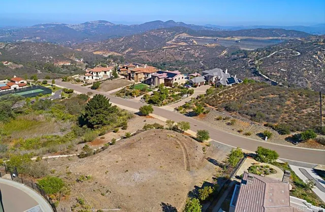 an aerial view of a house with a mountain