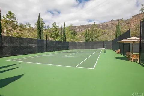 a view of a patio with table and chairs under an umbrella