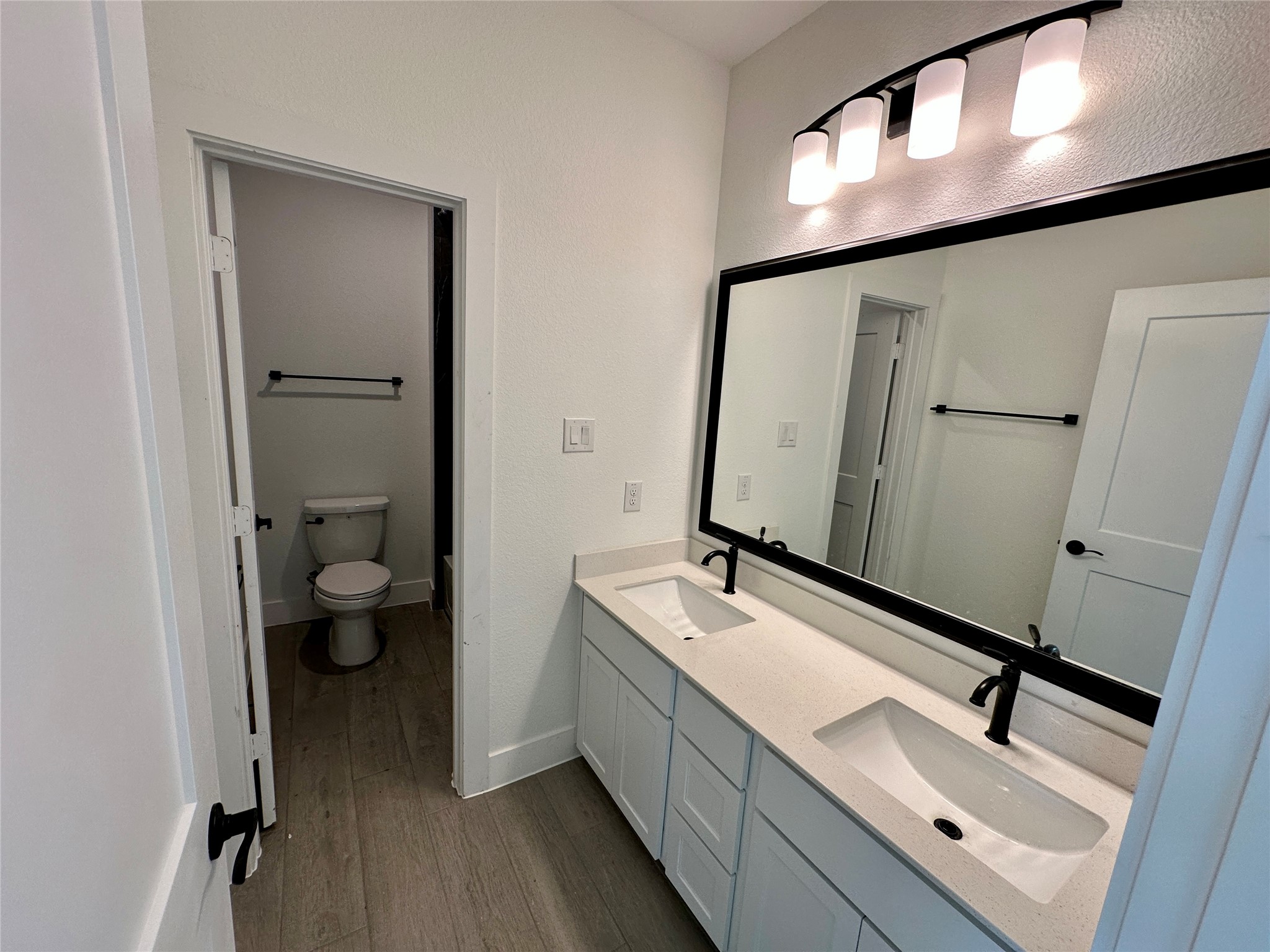 485 Lone Ranger Drive Montgomery, TX 77316 - Photo 17 of 32 a bathroom with a double vanity sink and a mirror