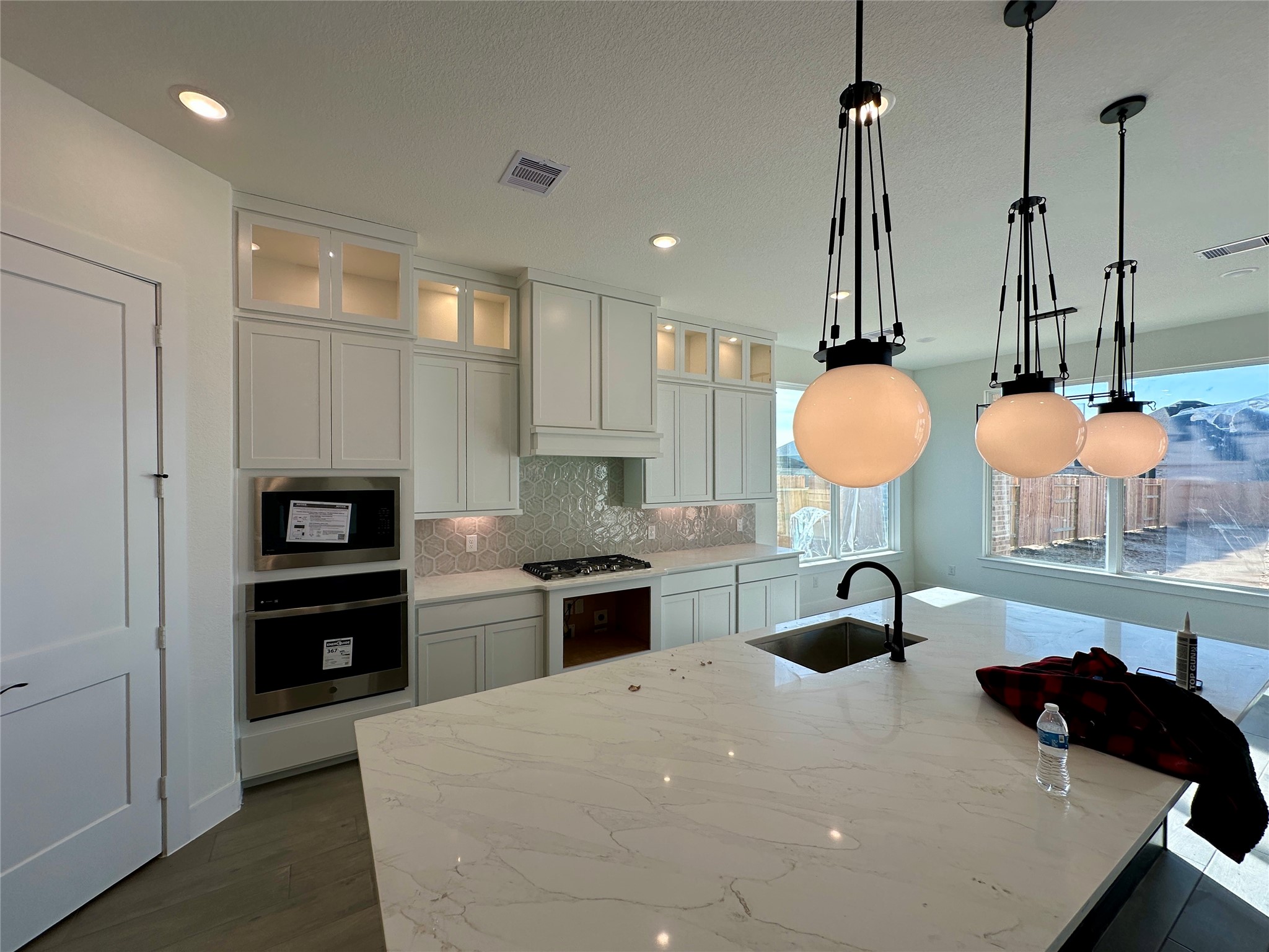 485 Lone Ranger Drive Montgomery, TX 77316 - Photo 3 of 32 a kitchen with stainless steel appliances a stove a sink and a refrigerator