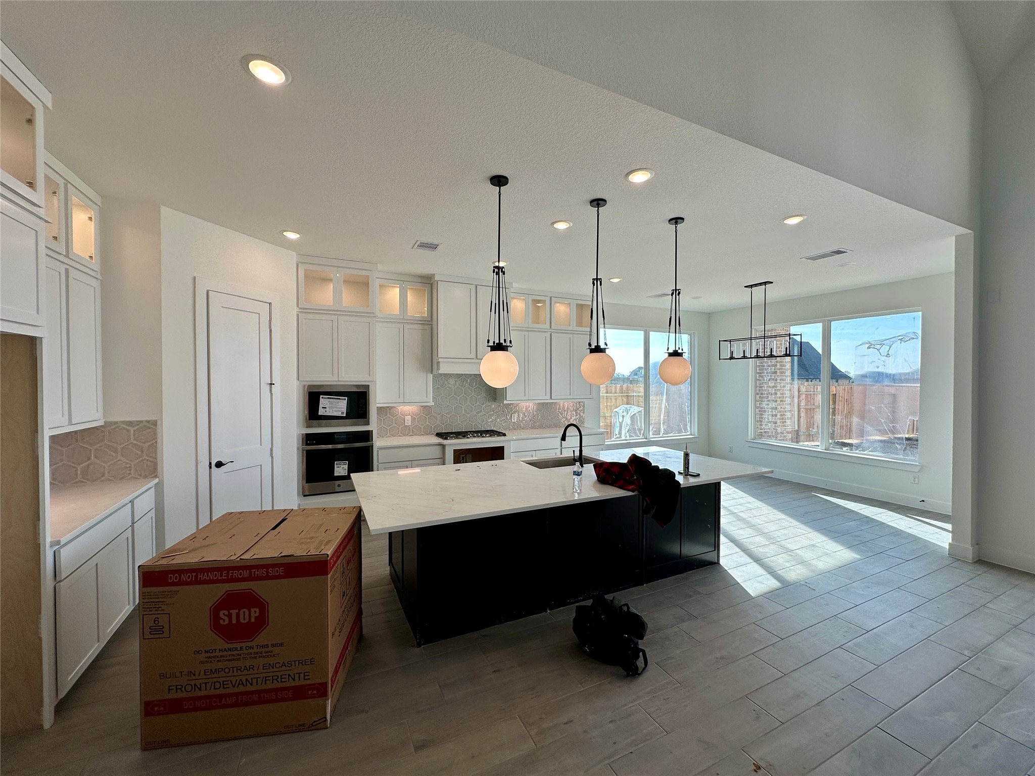 485 Lone Ranger Drive Montgomery, TX 77316 - Photo 4 of 32 a living room with kitchen island furniture and a chandelier
