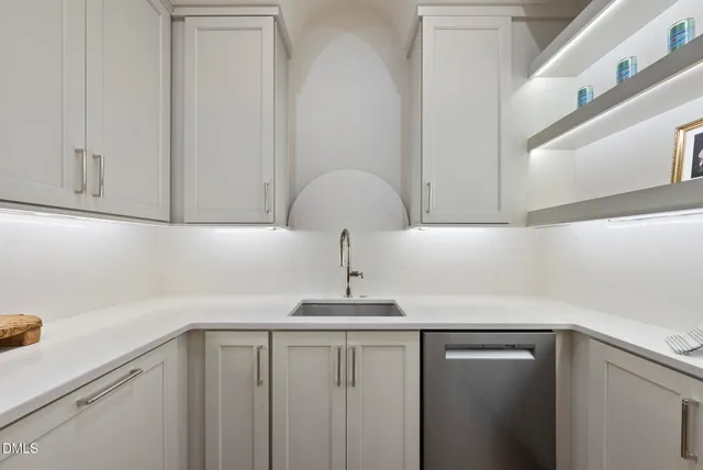 a view of a patio with couches chairs potted plants and wooden floor