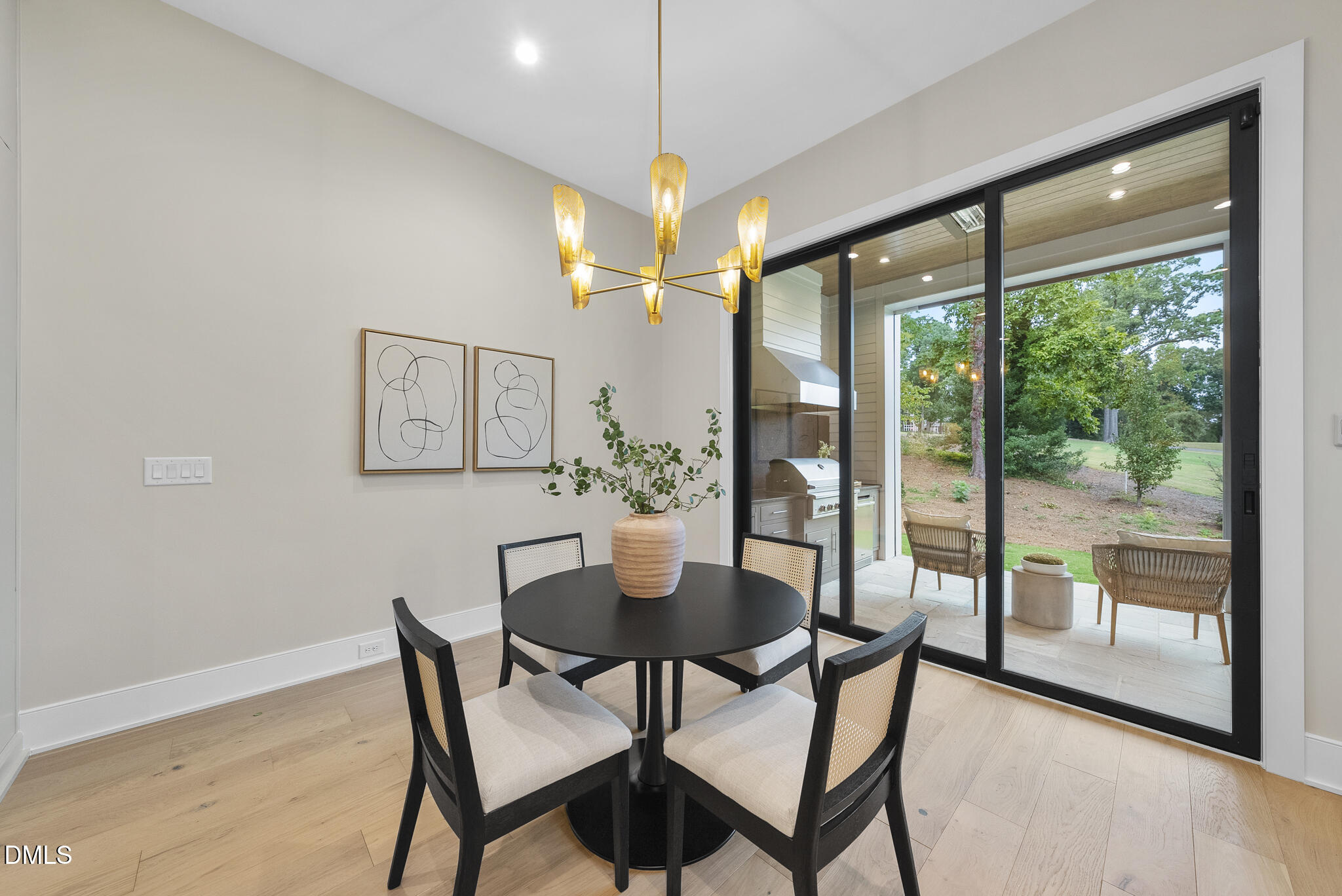 7000 North Ridge Drive Raleigh, NC 27615 - Photo 16 of 79 a dining room with furniture a chandelier and wooden floor