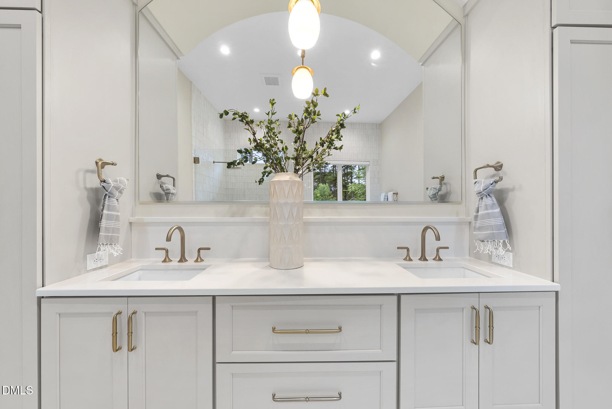 7000 North Ridge Drive Raleigh, NC 27615 - Photo 25 of 79 a bathroom with a sink a potted plant and a mirror