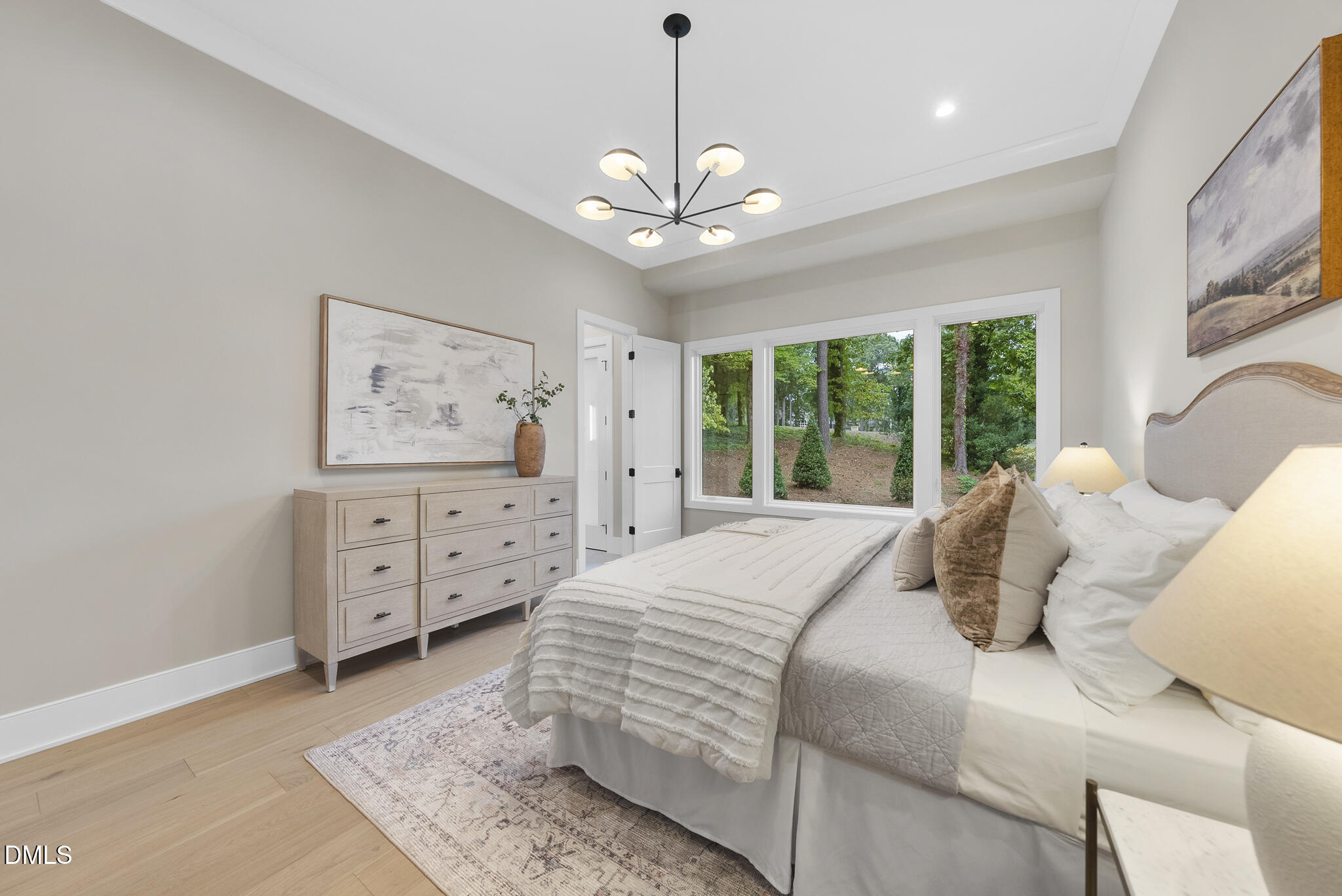 7000 North Ridge Drive Raleigh, NC 27615 - Photo 32 of 79 a bedroom with a large bed and a window