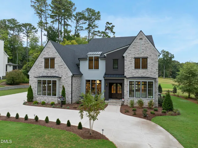a dining room with furniture a chandelier and wooden floor