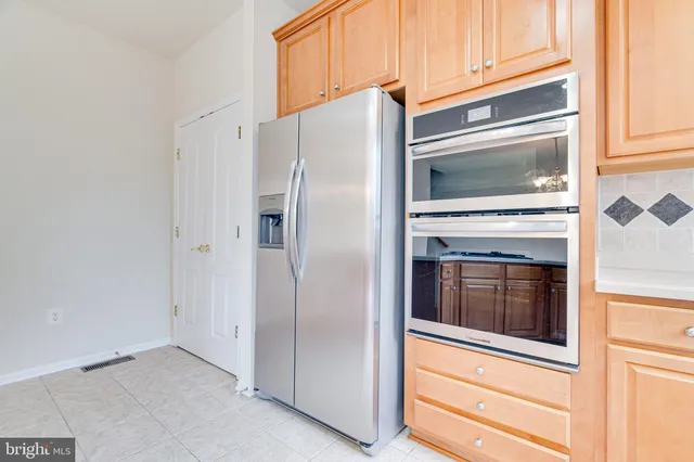a kitchen with cabinets and stainless steel appliances