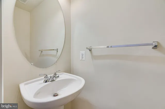 a bathroom with a sink a mirror and vanity