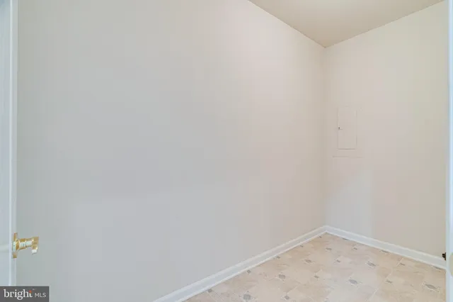 a view of staircase with white walls and a window