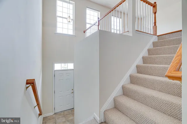 a view of a backyard with wooden fence and trees