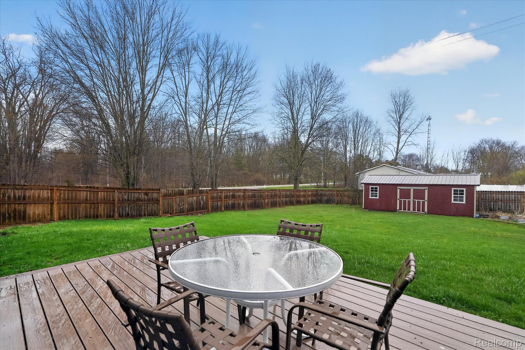 13508 North Center Road Clio, MI 48420 - Photo 6 of 38 Deck featuring outdoor dining area, a fenced backyard, and a storage shed
